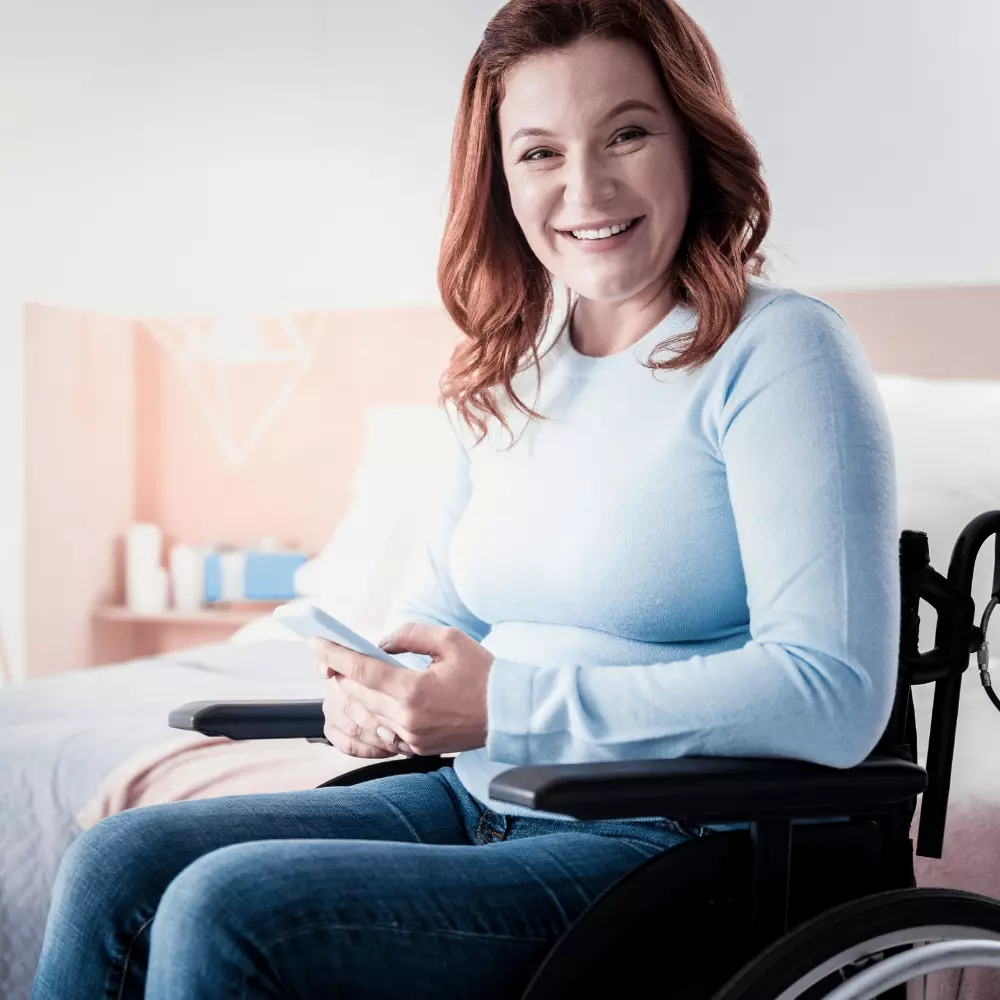 Woman in wheelchair smiling at camera